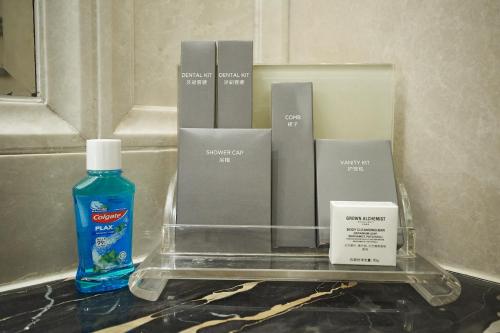 a bottle of soap and other products on a counter at Grand Hotel Haikou - Managed by Accor in Haikou