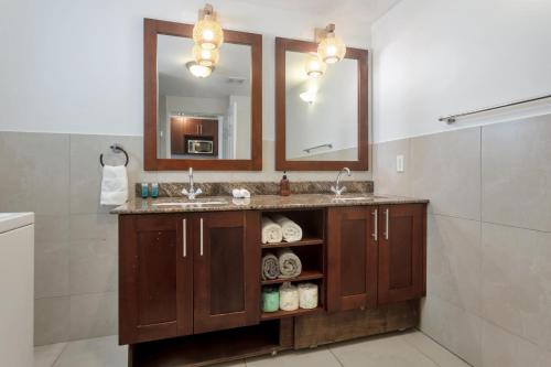 a bathroom with a sink and a mirror at Sand Bar Cove - Beach Bar Studio next to The Morgan Resort in Maho Reef