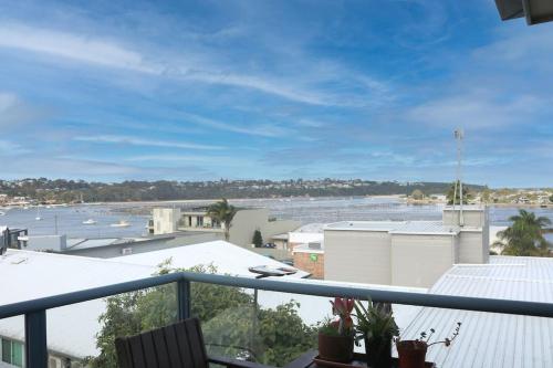 a balcony with a view of a body of water at Beech Break - 3 bedroom pet friendly apartment in Merimbula