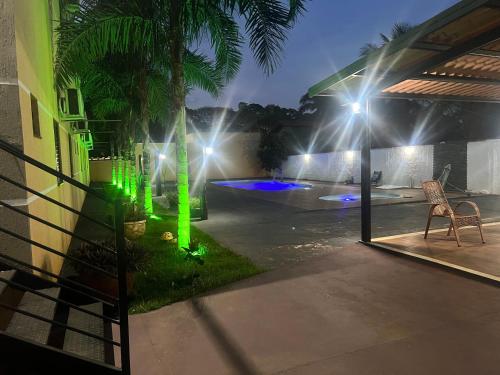 a night view of a patio with green lights at HOTEL E RESTAURANTE NA CHÁCARA in Dourados