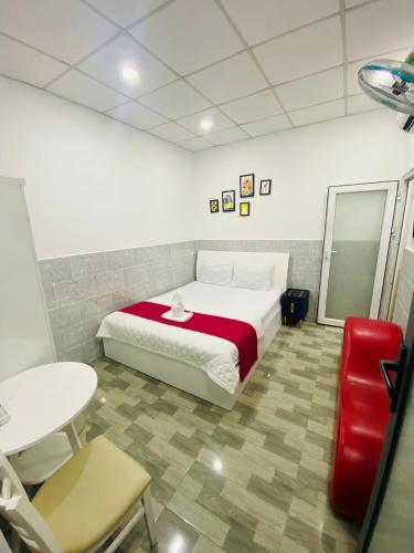 a bedroom with a bed and a table and chairs at Vĩnh Phú Gia Hotel in Ho Chi Minh City