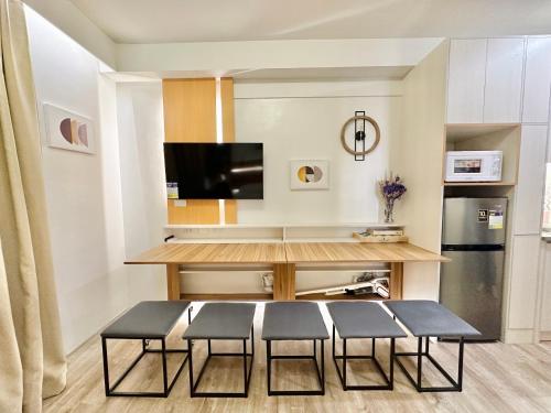 a living room with a table and chairs and a kitchen at UNIT B218 in Bacolod
