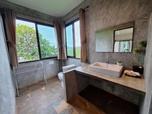 a bathroom with a sink and a mirror at Seabreeze @ Koh Mak in Ko Mak