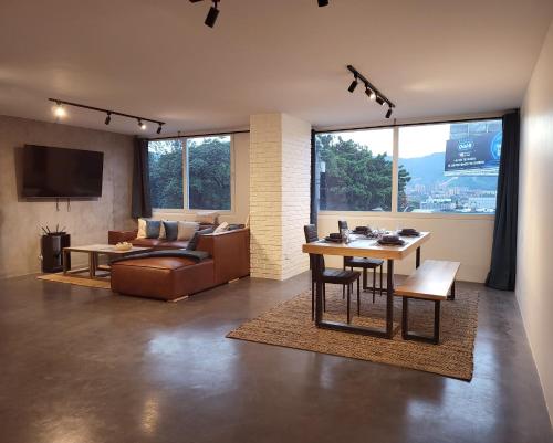 a living room with a couch and a table at Center City Flats - Apartments in El Poblado near Park Lleras, Medellin! in Medellín