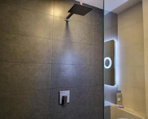 a shower with a glass door in a bathroom at Center City Flats - Apartments in El Poblado near Park Lleras, Medellin! in Medellín