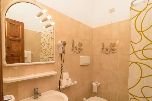 a bathroom with a sink and a mirror at Hotel Villa Fiorentina in Ischia