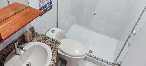 a small bathroom with a toilet and a sink at Center City Flats - Apartments in El Poblado near Park Lleras, Medellin! in Medellín