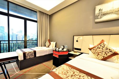 a hotel room with two beds and a large window at Maison 101 Dang Wangi in Kuala Lumpur