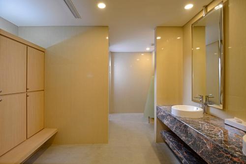 a bathroom with a sink and a mirror at Surya Hotel & Cottages Prigen in Tretes
