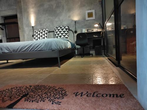 a bedroom with a bed and a desk in a room at Sengal Boutique Hotel in Auroville