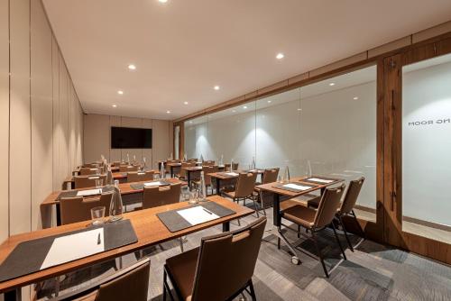a conference room with tables and chairs and a screen at La Siesta Classic Hang Thung in Hanoi