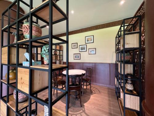 a room with a table and shelves of books at The Borneo Hotel in Kuching
