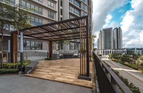 a pergola on a balcony of a building at Family-Friendly 3-Bedroom Condo at IOI Resort City in Kampong Abu Bakar