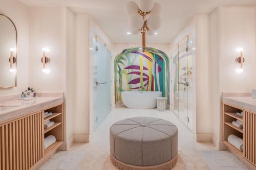 a bathroom with a tub and a sink and a bath tub at The Ritz-Carlton, Grand Cayman in George Town