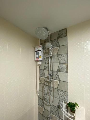 a shower in the corner of a bathroom at Private room hosted by Boyce 401 in Chiang Mai