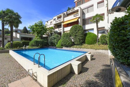 a swimming pool in front of a building at Holiday Home With Pool In Agno - Happy Rentals in Agno