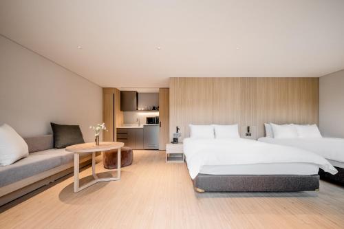 a hotel room with two beds and a couch at Phoenix Resort Pyeongchang in Pyeongchang 