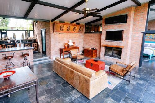 a living room with a couch and a fireplace at Brickyard Retreat at Mutianyu Great Wall Adjoin to Mutianyu Great Wall - Room with the View of Great Wall - Chinese massage experience - Vehicle Shuttle Service - International Catering - SPA& Nail Beauty Facilities in Huairou