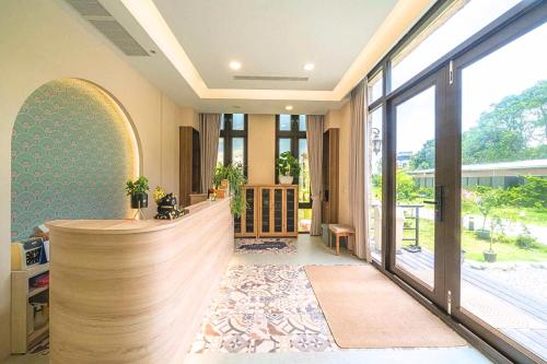 a hotel lobby with a reception desk and large windows at 花蓮壽豐 - Twinkle Night 星空說民宿A館 in Zhixue