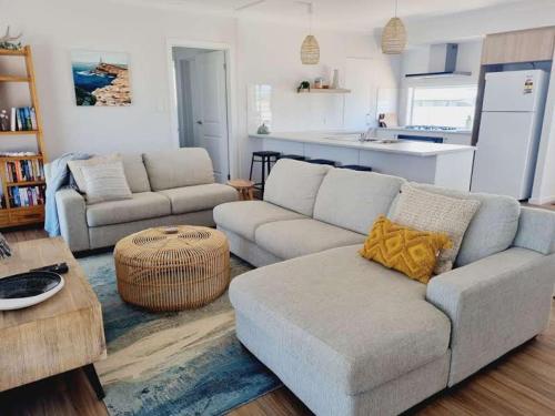 a living room with a couch and a table at Surfmist House in Robe