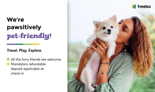 a woman holding a dog in her hands at Treebo Trend Desert Harmony Resort in Sām