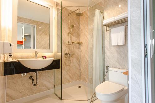 a bathroom with a sink and a toilet and a shower at Tour De Phuket Hotel - SHA Plus in Thalang