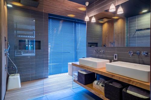 a bathroom with two sinks and a shower at Yasuragi in Niseko