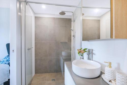 a bathroom with a sink and a shower at HOT Stylish Costal 3 ensuite apartment on Redcliffe, Brisbane in Redcliffe