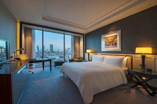 a hotel room with a large bed and a desk at Hilton Istanbul Bomonti in Istanbul