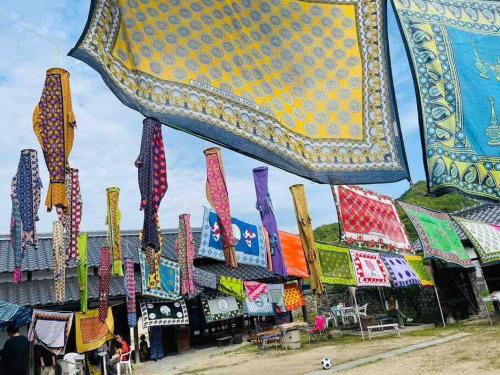 a market with a bunch of different colored ties at 自然素材でリノベした木の香り漂う貸切宿｜藤野民宿（Fujino Guest House） in Fujino