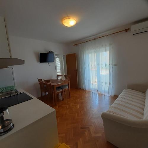 a living room with a couch and a table at Piadora in Banjol