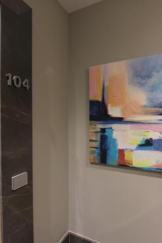 a painting hanging on a wall in a room at Boutique Hotel Adelar in Tirana