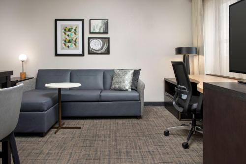 a living room with a couch and a table at Residence Inn Birmingham Hoover in Hoover