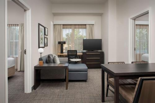 a living room with a couch and a tv at Residence Inn Birmingham Hoover in Hoover