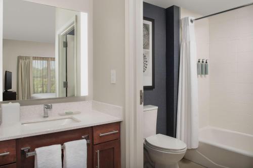 a bathroom with a sink and a toilet and a tub at Residence Inn Birmingham Hoover in Hoover