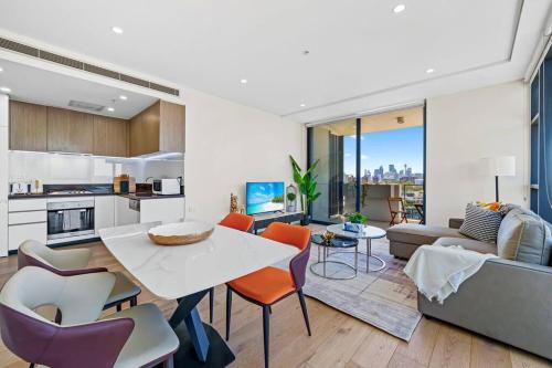 a kitchen and living room with a table and chairs at City View 2 Bedrooms apt in Waterloo in Sydney