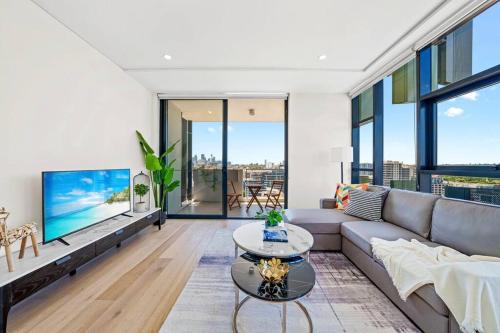 a living room with a couch and a table at City View 2 Bedrooms apt in Waterloo in Sydney