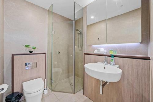 a bathroom with a shower and a sink and a toilet at City View 2 Bedrooms apt in Waterloo in Sydney