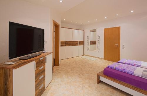 a living room with a flat screen tv on a dresser at Montelux Apartments in Budva