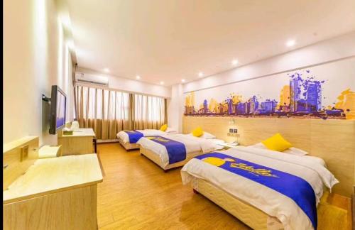 a hotel room with two beds and a tv at 7 Days Inn Foshan Lecong Furniture Branch in Shunde