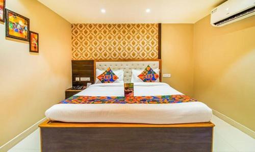 a bedroom with a large bed in a room at FabHotel SVR in Patna