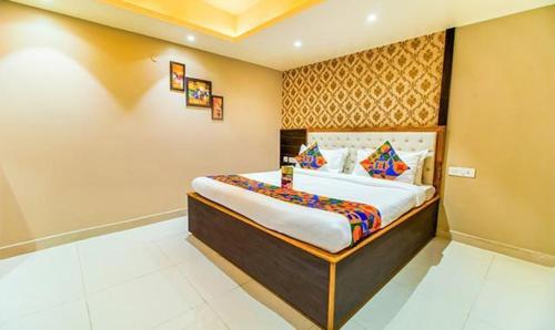a bedroom with a large bed in a room at FabHotel SVR in Patna