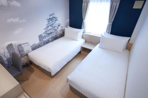 a small room with two beds and a window at Travelodge Honmachi Osaka in Osaka