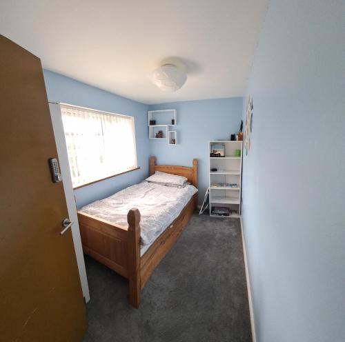 a small bedroom with a bed and a window at Homely Home in Buckinghamshire