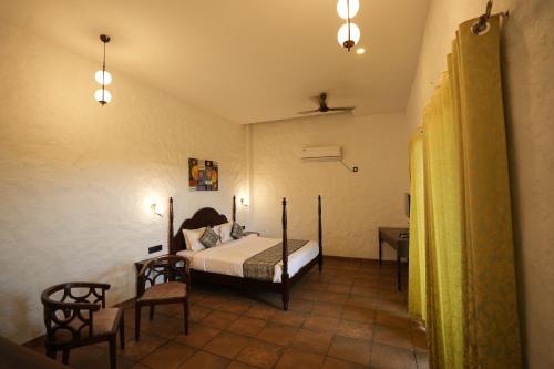 a bedroom with a bed and two chairs in it at Waterstone resort in Linga