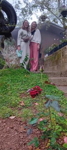two women standing next to each other in a garden at Ella green stay in Ella