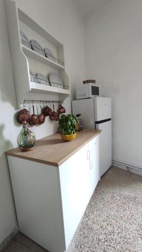 a kitchen with white cabinets and a white refrigerator at Al Numero 5 in Tivoli