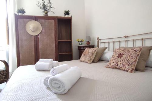 a bedroom with a large white bed with towels on it at Al Numero 5 in Tivoli