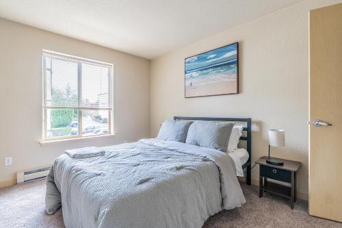 a bedroom with a bed and a window at Beautiful and cozy one bedroom apartment -WiFi, BBQ, Patio, Dog park, close to Greenlake and Northgate in Seattle