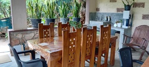 a dining room table and chairs with a table and a table and chairs at Ella green stay in Ella